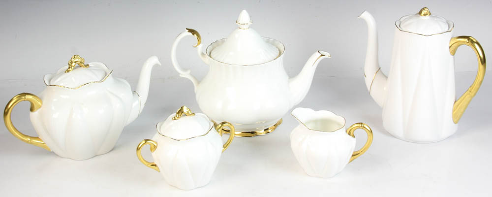 English Shelley tea set, ivory color with gold rim, with a Royal Albert teapot. Five (5) pieces