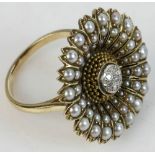 14k yellow gold flower shaped ring with center cluster of seven round diamonds, surrounded by petals