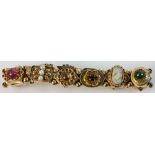 14k yellow gold bracelet with various stones, pearls, coral, etc., approximately 6 1/2" L,