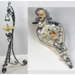 Victorian wrought iron stand with brass teapot, 42" H, and French faience bellows wall hanging,