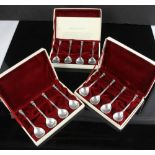 Twelve (12) Elizabethan seal-top spoons (in three separate velvet-lined boxes), fascimile finished