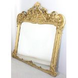 Large ornate gilt mirror, 62" H x 64" W. Provenance: Millis, Massachusetts estate. Provenance: