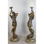 Pair of bronze male and female lights standing on fish, 63" H. Provenance: Malibu, California