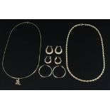 Group of 14k gold jewelry, including rope-turned chain, chain with initial 'M', and three pairs of