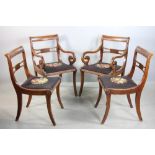 Four mahogany chairs with needlepoint seats, including two armchairs and two side chairs.