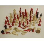 Box containing a quantity of stained ivory chess pieces of varying sizes and styles (qty)