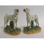 Pair of Staffordshire standing Dalmatians on a foliage base, (one tail a/f), 15cms wide x 16cms tall