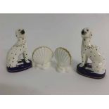 Pair of miniature Staffordshire seated Dalmatians on a blue oval plinth with gilded rim, together