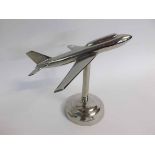 Chromium model of an aeroplane supported on a cylindrical column and a stepped circular base,