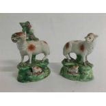 Pair of Staffordshire figures of ram and ewe each standing beside bocages (salt) a/f, approx 13cms