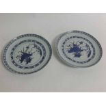 Pair of 20th century Japanese blue and white plates with a pitted border and central floral