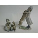 Two Lladro groups, girl embracing a dog and seated boy with bitch and puppies, 26 and 13cms high (2)