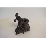 Unusual base metal figure decorated inkwell, 16cms high