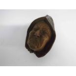 Small carved and painted softwood mask of a sad monk, 17cms x 10cms, small losses, together with a