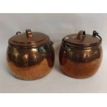 Two large Victorian copper cauldrons and lids with iron swing handles, one 33cms tall, the other