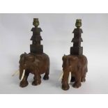 Pair of Oriental hardwood elephants, their temple formed backs with attached electric light holders,