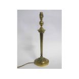 Regency style brass table lamp with circular loaded base and fluted stem, 43cms tall