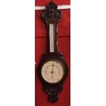 Early 20th century oak cased aneroid wheel barometer, the C-scroll and foliate carved case set