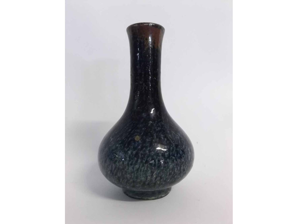 Heavily potted Chinese porcelain vase with thick mottled glaze going from dark red through dark blue