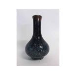 Heavily potted Chinese porcelain vase with thick mottled glaze going from dark red through dark blue