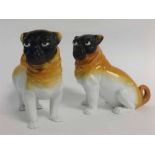 Two late 19th/early 20th century Austrian pug dog ornaments, one seated and with Victoria factory