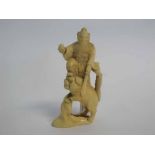 Late 19th/early 20th century Japanese ivory okimono of a warrior slaying a beast, 15cms tall,