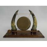 Oak formed and metal gong stand with brass gong and treen striker, 40cms wide x 27cms tall