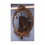 Large Victorian girandole of oval shape with gilt gesso scroll and pierced work to the top,