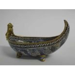 Doulton and Rix "marqueterie" boat shaped bowl with handle, modelled as a gilt cherub, black printed