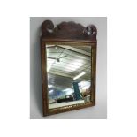 Small Georgian mahogany and parcel gilt framed wall mirror, rectangular shaped with fret cut