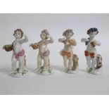 Group of four Naples Pottery porcelain figures of Bacchanalian putti, blue printed marks, 12cms tall