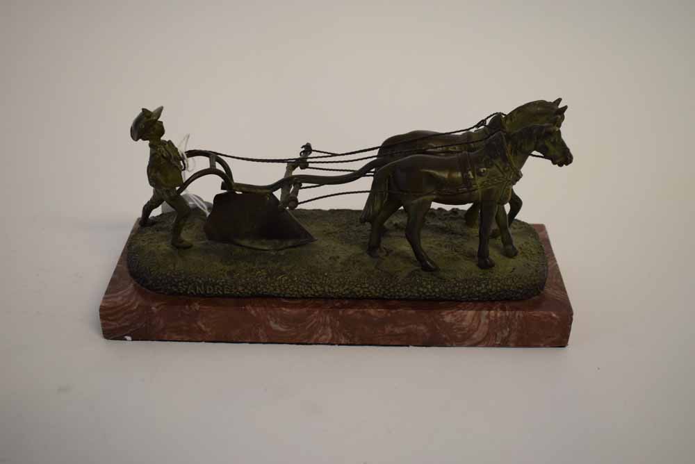 Bronze group of two horses drawing a plough with a young man to back, raised on a red marble plinth,