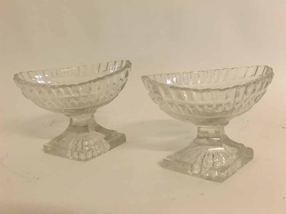 Pair of early 19th century faceted oval pedestal glass salts on diamond shaped bases, 3ins high
