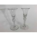 Pair of 18th/19th century ale glasses with knopped stems and air twist decoration, raised on a