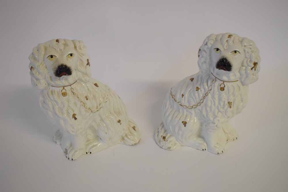 Pair of 19th century white glazed Staffordshire dogs with gilded chain and decoration, each 23cms