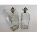 Pair of Georgian square formed clear cut glass decanters, with star cut bases and plated stoppers,