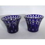 Pair of blue overlaid glass vases of squat fluted form with star cut base, each 13cms tall