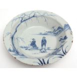 Mid-18th century English Delft shallow bowl, (probably London), decorated with two Chinese figures