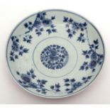 Chinese porcelain circular dish, the interior in underglaze blue with floral sprays and roundels,