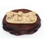 Small finely carved Japanese okimono of a group of five ShiShi on an integral flat base with