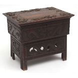 Unusual Oriental hardwood small work table with folding support, the lifting lid moulded with
