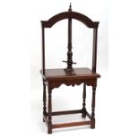 19th century oak table napkin press, typical arched top, central spindle over a plain frieze, raised