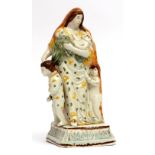 Platware figure of Charity, modelled in typical colours, circa 1790 of a lady holding a baby with