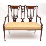 Edwardian salon sofa with double chair back, crested on either side with marquetry panels, splayed