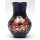 Moorcroft baluster vase decorated with an anemone design on a dark blue ground, impressed