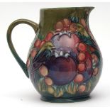 Modern Moorcroft baluster jug in "Finches" pattern to a mid-green ground, green painted monogram and