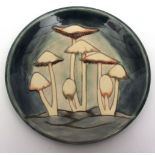 Modern Moorcroft circular cabinet or wall plate, "Toadstool" pattern to a grey and green ground,