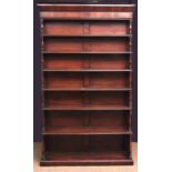 19th century mahogany "waterfall" bookcase with moulded cornice over six fitted shelves, with plinth