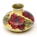 Moorcroft baluster vase of squat design, decorated with "Hibiscus" pattern to a lemon ground, blue
