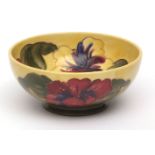 Moorcroft small circular bowl, decorated in red and yellow "Hibiscus" pattern, 16cms diam,